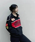 Female model wearing a drop shoulder aesthetic Unisex Black Ferrari Racing Jacket 