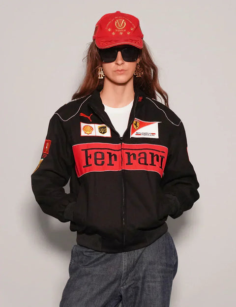 Person wearing a Women Black Ferrari Racing Jacket with red accents on a plain background