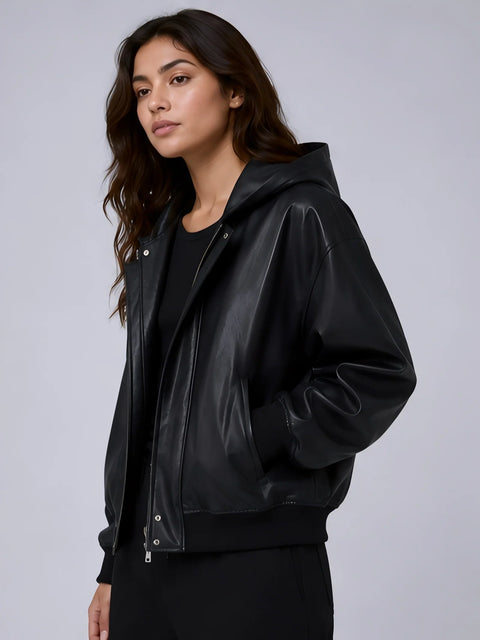 Woman wearing a black leather jacket against a gray background