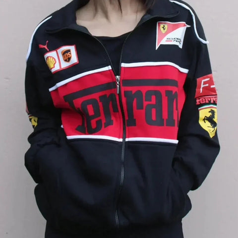 Black, red, and white Ferrari tracksuit jacket with various logos on a plain background