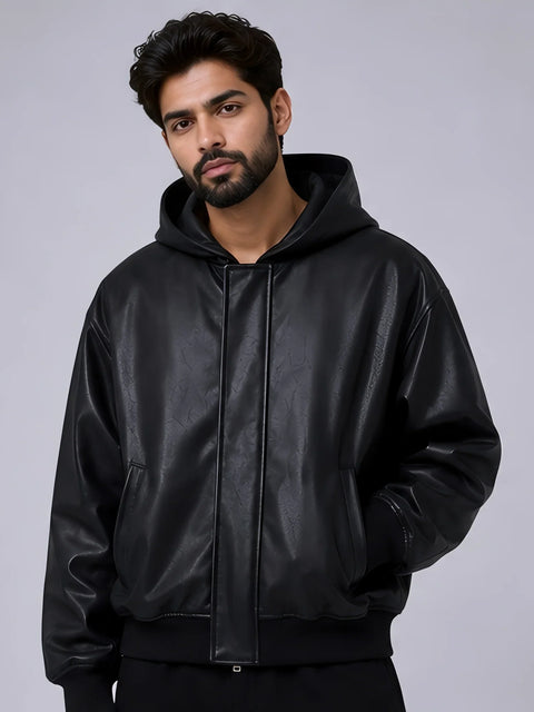 Man wearing a men-hooded-leather-jacket against a gray background