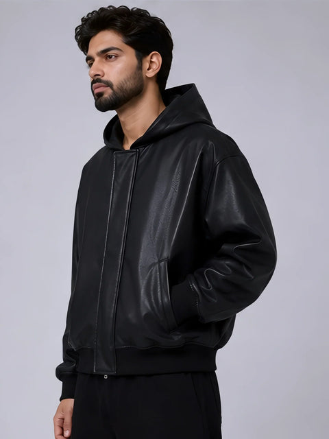 Man wearing a black leather jacket on a gray background