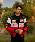 Person wearing a Ferrari jacket with logos in an outdoor setting